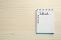 Notepad with unfilled To Do list on wooden table, top view. Space for text