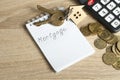 Home savings, budget, financial and property concept. Model house, keys, calculator , coins and notepad with word Royalty Free Stock Photo