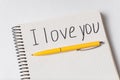 Notepad with words I LOVE YOU. Copybook and pen on white background, close up Royalty Free Stock Photo
