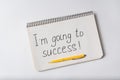 Notepad with the words Im going to success on white background. Handwritten Royalty Free Stock Photo