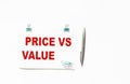 Notepad with the words Price versus value , on a white background with a pen. Place to write