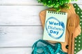 Notepad with World Diabetes Day text on chopping board with wood