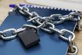Notepad for writing wrapped with an iron chain with an open lock concept information protection data protection