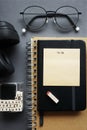 Notepads next to pen, sticky notes, glasses and headphones Royalty Free Stock Photo