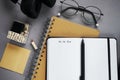 Notepads next to pen, sticky notes, glasses, smartphone and headphones Royalty Free Stock Photo
