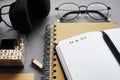 Notepads next to pen, sticky notes, glasses, smartphone and headphones Royalty Free Stock Photo