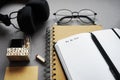 Notepads next to pen, sticky notes, glasses, smartphone and headphones Royalty Free Stock Photo