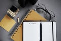 Notepads next to pen, sticky notes, glasses, smartphone and headphones Royalty Free Stock Photo