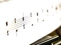 Notes close up macro on a sheet of paper. Music and sound. Royalty Free Stock Photo