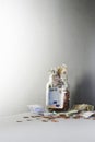 Notes and coins overflowing from jar Royalty Free Stock Photo