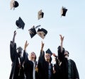 Nothing beats that feeling of achieving your goals. Shot of a group of students throwing their hats in the air on Royalty Free Stock Photo