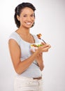 Nothing beats a healthy meal. Portrait of a young woman enjoying a salad. Royalty Free Stock Photo