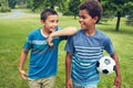 Nothing better than footie with your best bud. two young boys out for a game of soccer in the park.