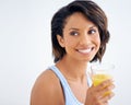 Nothing better than a refreshing glass of juice. a beautiful young woman enjoying a glass of fresh orange juice. Royalty Free Stock Photo