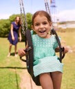 Nothing better than a swing. a young girl playing on a swing outsdie. Royalty Free Stock Photo