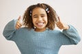 Nothing but good vibes. an adorable little girl standing alone and showing a thumbs up.