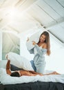 Nothing ignites intimacy like fun. a happy and playful young couple having a pillow fight in bed. Royalty Free Stock Photo