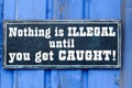 Nothing is illegal until you get caught plate Royalty Free Stock Photo