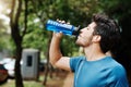 Nothing like water to refuel the engine. a sporty young man drinking water out of a bottle after having a jog outside Royalty Free Stock Photo