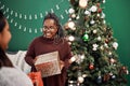 Nothing more glittery than the gift of togetherness. two happy young women exchanging gifts during Christmas at home. Royalty Free Stock Photo