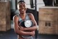 Nothing motivates me more than results. a fit young woman holding a weighing scale while at the gym.