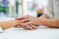 Nothing but patience for her patients. a pharmacist compassionately holding a customers hand. Royalty Free Stock Photo