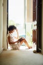 Nothing quite as relaxing as a good read. a young woman relaxing with a book at home. Royalty Free Stock Photo