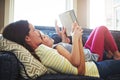 Nothing says bonding time like story time. a mother and her daughter reading a book together on the sofa at home. Royalty Free Stock Photo