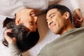 Nothing says holidays like a cheesy love. Shot of a young couple laying on the floor at home. Royalty Free Stock Photo