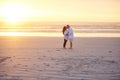 Nothing says romance like a sunset kiss. a mature couple kissing on the beach.