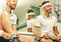 Nothing but smiles in this locker room. two young men getting dressed in the locker room after a game of squash. Royalty Free Stock Photo