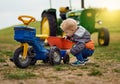 Nothing teaches self sufficiency like growing up on a farm. Shot of an adorable little boy playing with a toy truck on a Royalty Free Stock Photo