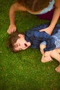 Nothing but tickles and giggles when theyre together. High angle shot of a young girl tickling her brother while playing