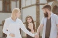 He is nothing but a womanizer. Hipster choosing between two women. Bearded man looking at other girl. Betrayal and Royalty Free Stock Photo
