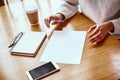 Nothing works better than just improving your product. Modern business woman working at wooden desk in modern office. Royalty Free Stock Photo