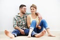 Nothings going to change my love for you. a loving young couple sitting beside each other on the floor at home. Royalty Free Stock Photo