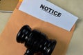 Notice in Brown envelope and judges gavel. Justice and law concept Royalty Free Stock Photo