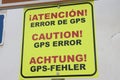 Notice of an error in the maps provided by GPS maps. Sign in German, English and Spanish Royalty Free Stock Photo