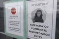 A notice sign instructs visitors to wear a face mask as a stipulated health precaution at the entrance of the medical clinic