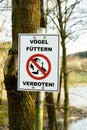 Notice sign `VÃÂ¶gel fÃÂ¼ttern verboten!` Translation: Do not feed the birds!