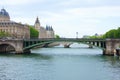 Notre Dame Bridge over the River Seine in Paris, France, with Bailiffs-Audienciers of the Commercial Court of the Seine and Royalty Free Stock Photo