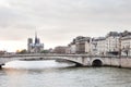 Notre Dame Cathedral on Ile de la Cite and Pont de la Tournelle over Seine river Royalty Free Stock Photo
