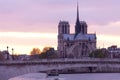 Notre Dame Cathedral on Ile de la Cite and Pont de la Tournelle over Seine river in Paris Royalty Free Stock Photo