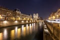 Notre Dame Cathedral and the Seine river in Paris at night, France Royalty Free Stock Photo