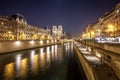 Notre Dame Cathedral and the Seine river in Paris at night, France Royalty Free Stock Photo