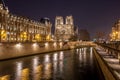 Notre Dame Cathedral and the Seine river in Paris at night, France Royalty Free Stock Photo