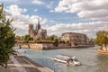 Notre Dame cathedral with tourist boat on Seine during spring time in Paris, France Royalty Free Stock Photo
