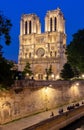 Notre-Dame de Paris cathedral and Cite island embankment at night, France Royalty Free Stock Photo