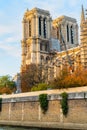 Notre Dame de Paris cathedral, France. Wonderful gothic architecture in autumn. View from the Seine river. Royalty Free Stock Photo