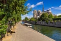 Notre Dame de Paris cathedral on Ile de La Cite with the Seine River in summer. Paris, France Royalty Free Stock Photo